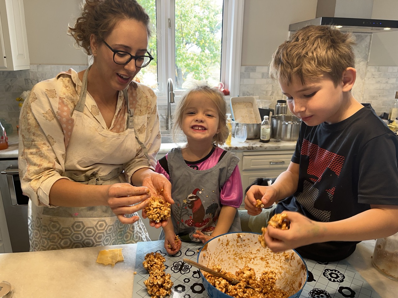 Family Making Caramel Popcorn For Decorations